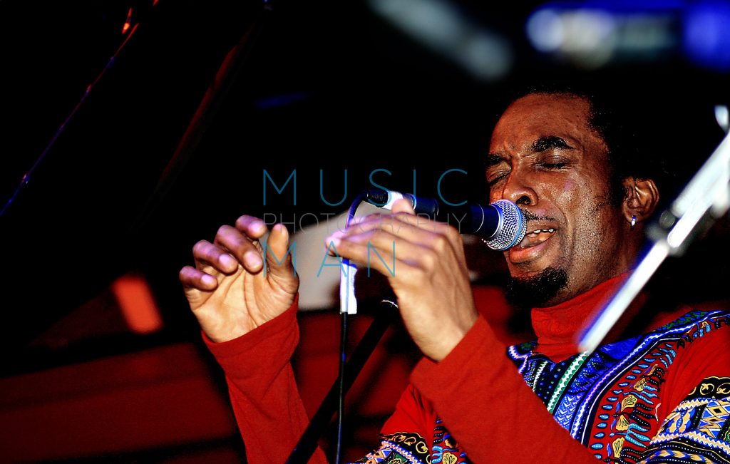 Detroit soul musician Amp Fiddler performing live in a red dashiki at the Jazz Café in London, vintage archival concert photography by Music Man Studio.
