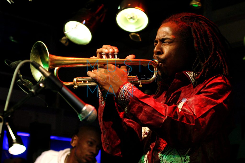 Jazz legend Roy Hargrove performing live on trumpet under stage lights at the Jazz Café in London, vintage archival print by Music Man Studio.