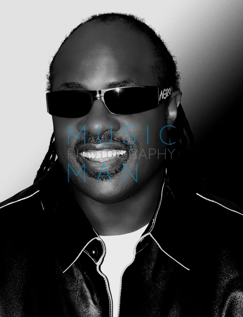 Music icon Stevie Wonder captured in a high-contrast black and white studio portrait during an exclusive private press event at the Savoy Hotel in London, photography by Music Man Studio.